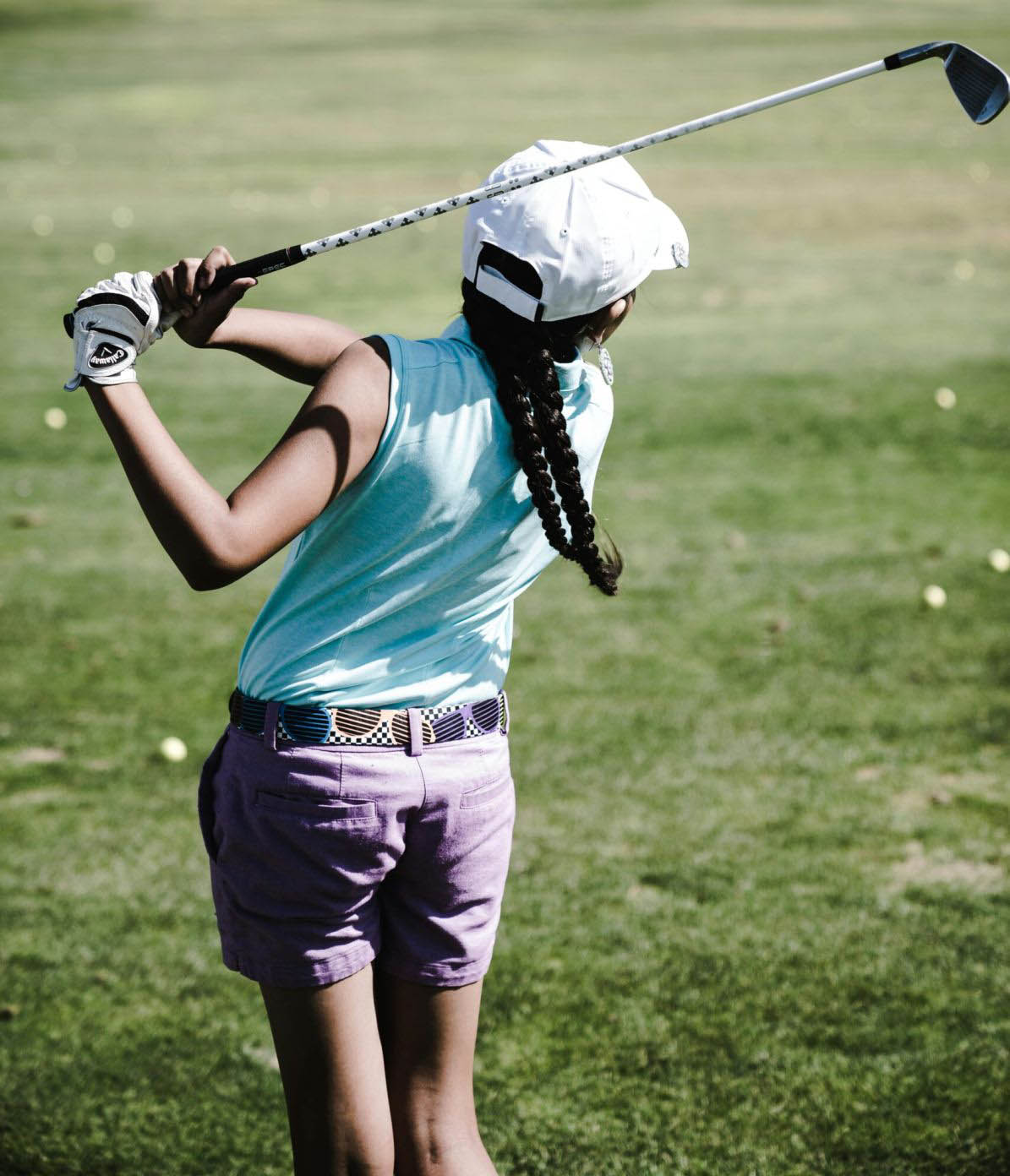 Golfer performing a powerful swing on the course, highlighting the importance of core strength and mobility for improving golf performance.